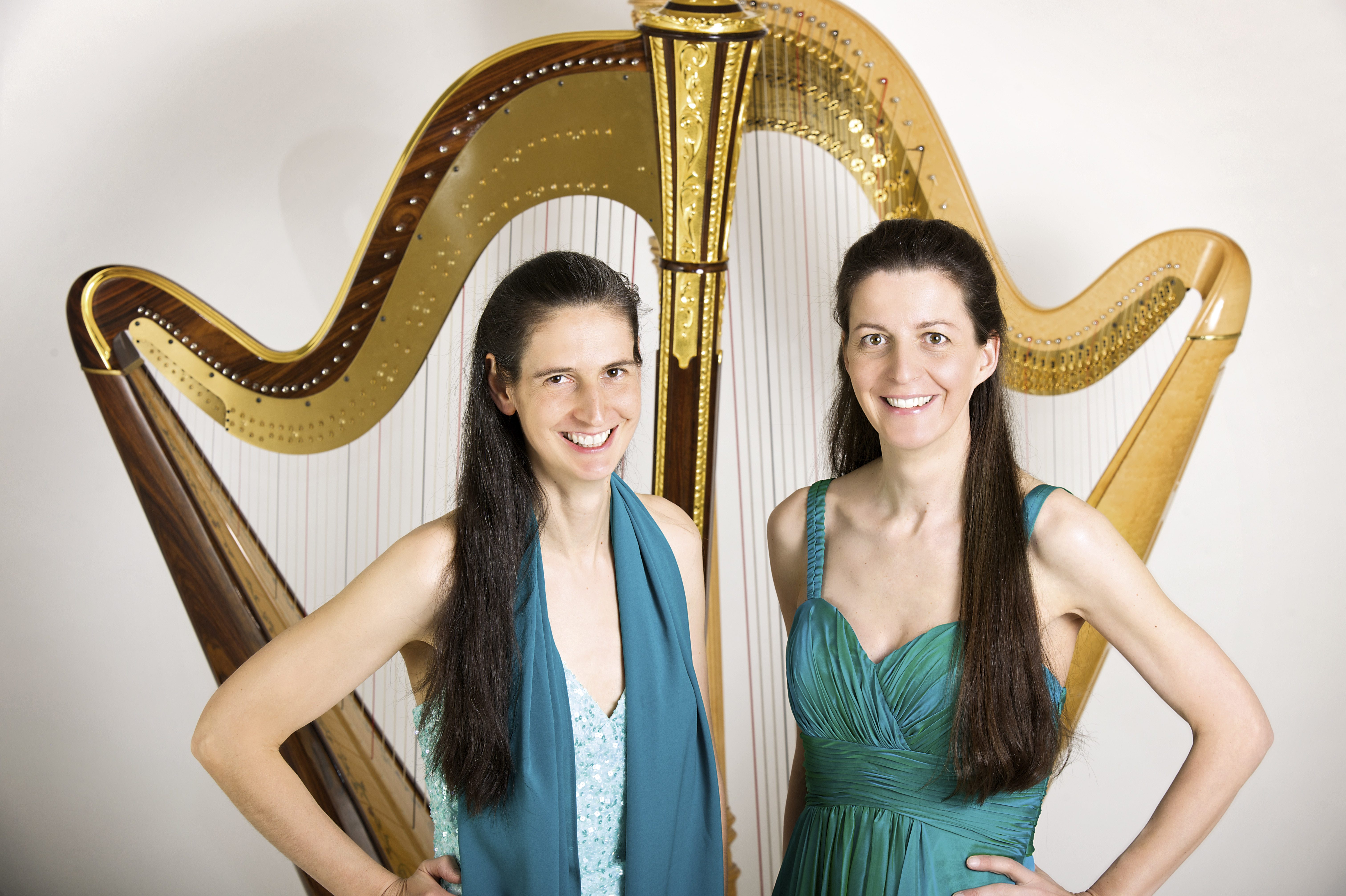 Regine Kofler und Silke Aichhorn  stehen vor ihren Harfen